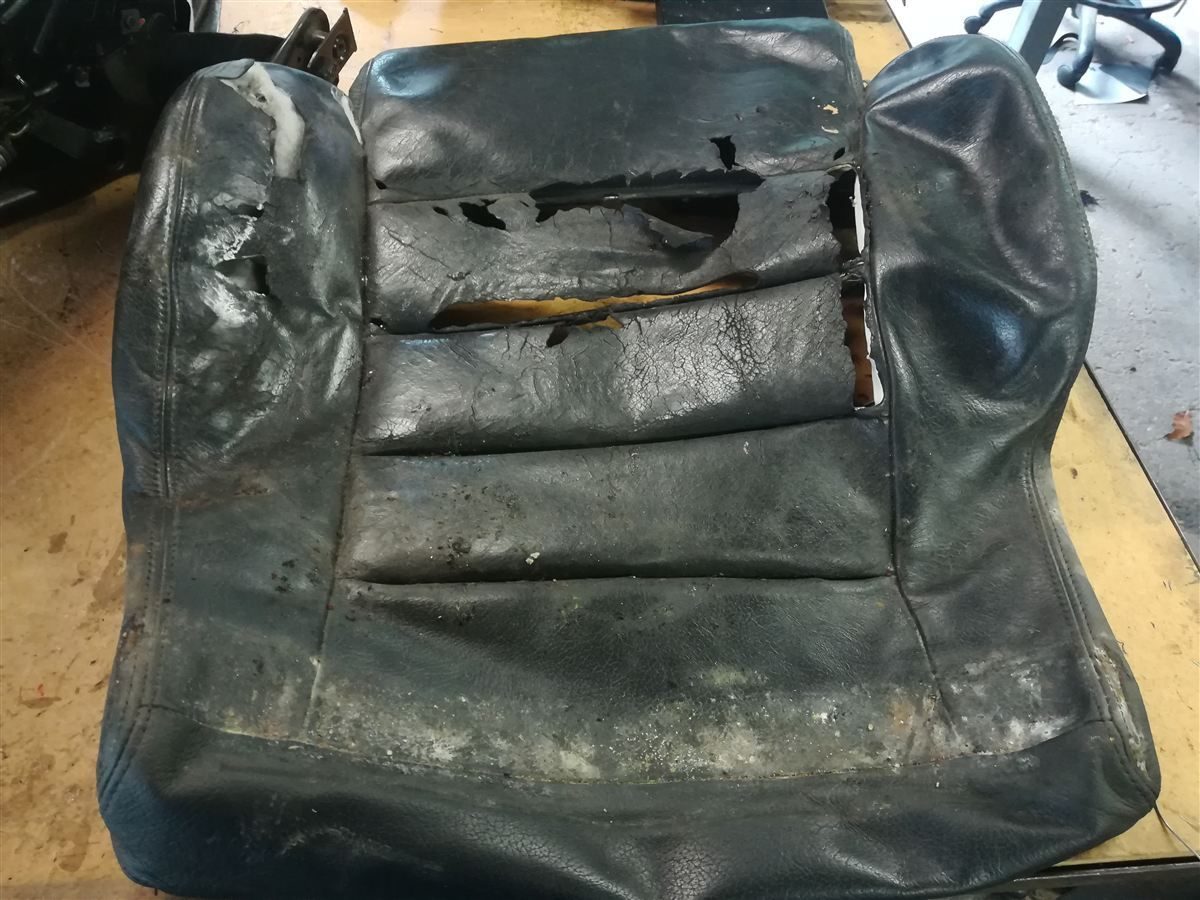 Worn leather seat before restoration